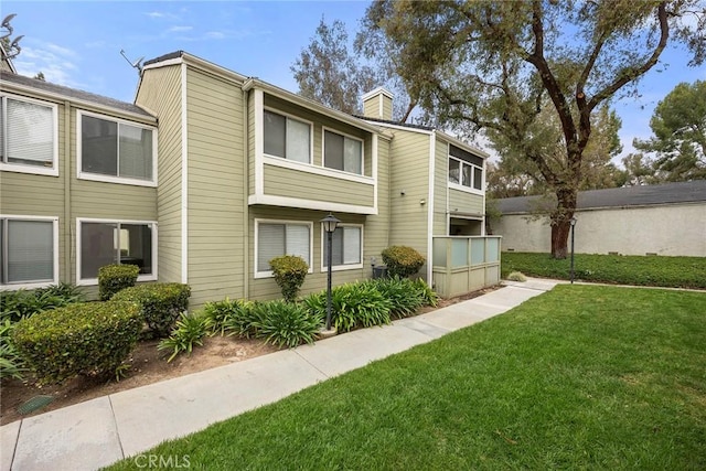 5814 Old Village Rd Unit 216, Yorba Linda, CA 92887 - back of property featuring a chimney and a yard