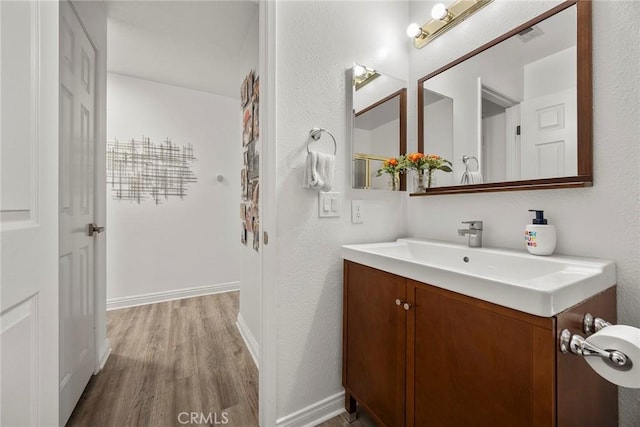 5814 Old Village Rd Unit 216, Yorba Linda, CA 92887 - bathroom featuring wood finished floors, vanity, and a textured wall
