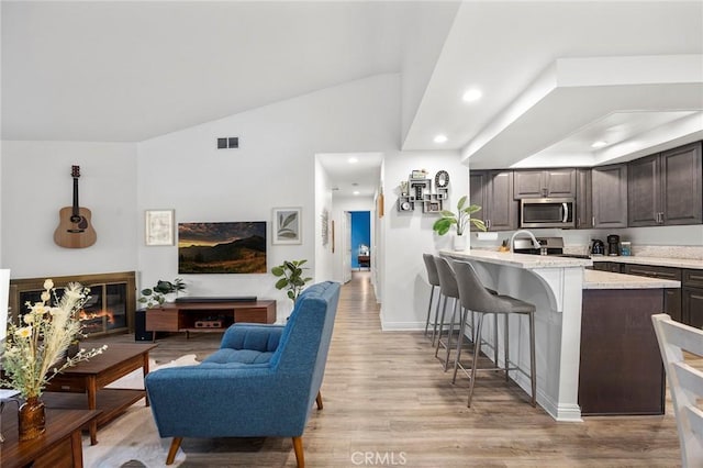 5814 Old Village Rd Unit 216, Yorba Linda, CA 92887 - living area featuring lofted ceiling, light wood finished floors, recessed lighting, and baseboards