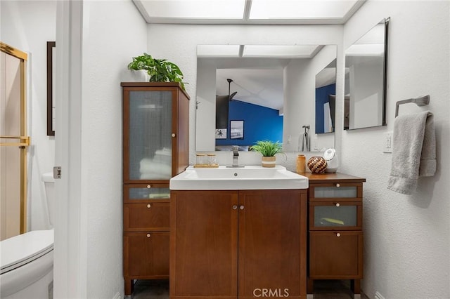 5814 Old Village Rd Unit 216, Yorba Linda, CA 92887 - full bath with vanity, toilet, a textured wall, lofted ceiling, and baseboards