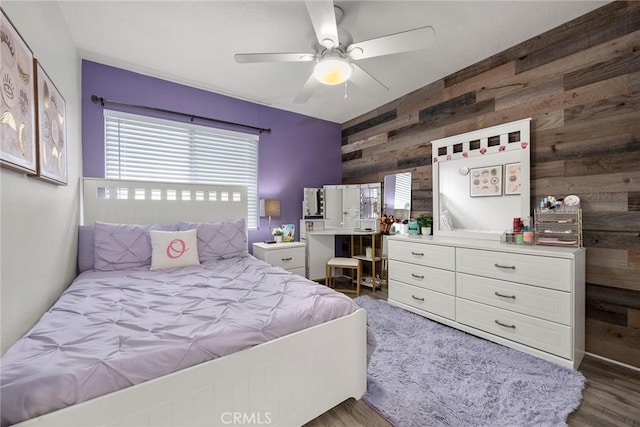 5814 Old Village Rd Unit 216, Yorba Linda, CA 92887 - bedroom with wooden walls, wood finished floors, a ceiling fan, and an accent wall