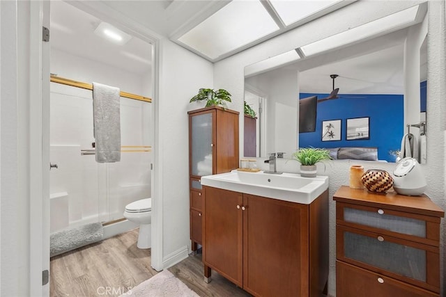 5814 Old Village Rd Unit 216, Yorba Linda, CA 92887 - bathroom featuring wood finished floors, a ceiling fan, toilet, a shower stall, and vanity