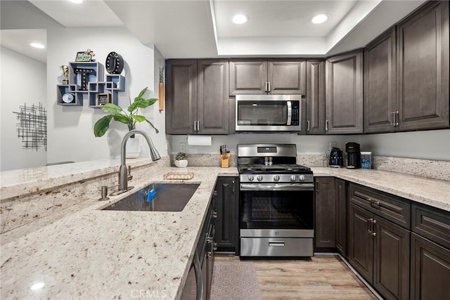 5814 Old Village Rd Unit 216, Yorba Linda, CA 92887 - kitchen with stainless steel appliances, a sink, light stone countertops, dark brown cabinetry, and recessed lighting