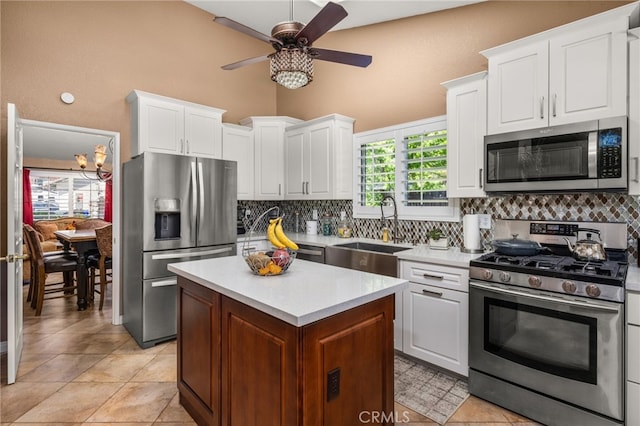 35189 Ravencrest Ct, Yucaipa, CA 92399 - kitchen with stainless steel appliances, ceiling fan, a sink, and backsplash