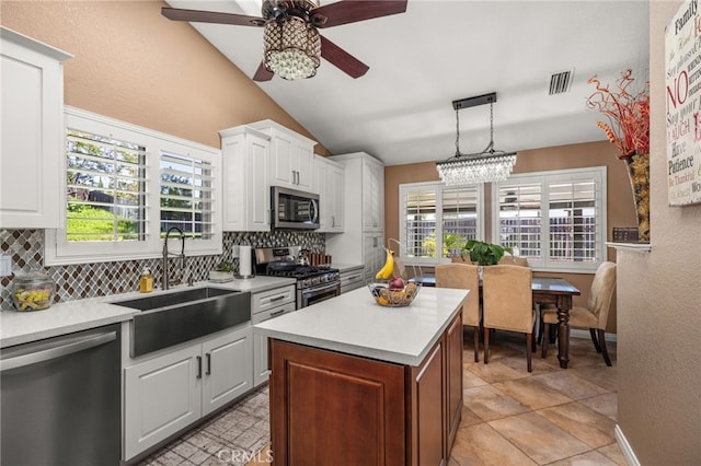 35189 Ravencrest Ct, Yucaipa, CA 92399 - kitchen featuring stainless steel appliances, a sink, a ceiling fan, backsplash, and lofted ceiling