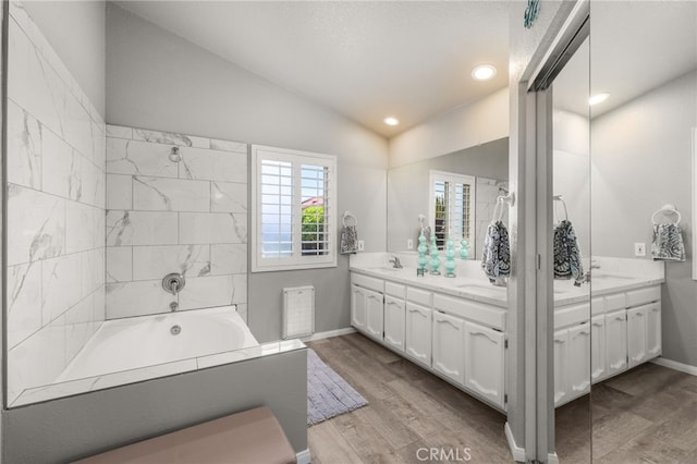 35189 Ravencrest Ct, Yucaipa, CA 92399 - full bath featuring lofted ceiling, double vanity, wood finished floors, a bathtub, and baseboards