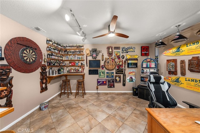 35189 Ravencrest Ct, Yucaipa, CA 92399 - home office with a ceiling fan, baseboards, a textured ceiling, and track lighting