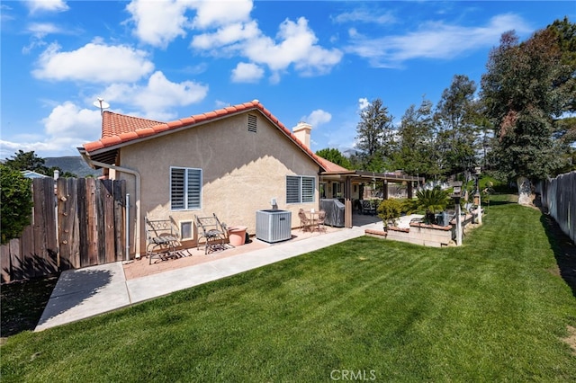 35189 Ravencrest Ct, Yucaipa, CA 92399 - rear view of property featuring a chimney, a patio area, a pergola, stucco siding, and central air condition unit