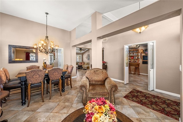 35189 Ravencrest Ct, Yucaipa, CA 92399 - dining space featuring a chandelier, ceiling fan, a towering ceiling, and baseboards
