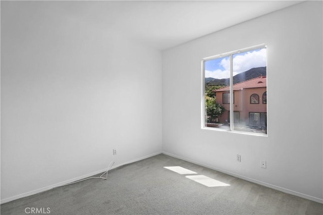 empty room with carpet and baseboards