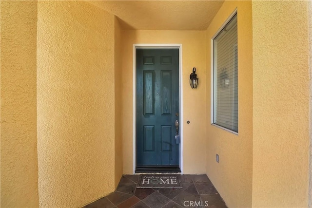 entrance to property with stucco siding
