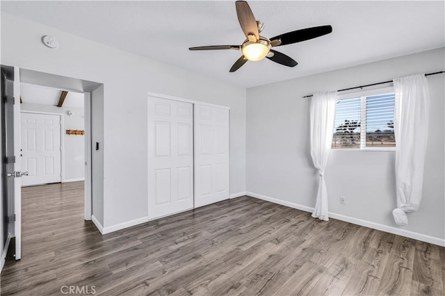 57330 Old Haggard Rd, Yucca Valley, CA 92284 - unfurnished bedroom with wood finished floors, a closet, baseboards, and ceiling fan