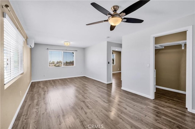57330 Old Haggard Rd, Yucca Valley, CA 92284 - unfurnished bedroom with wood finished floors, baseboards, ceiling fan, and a walk in closet