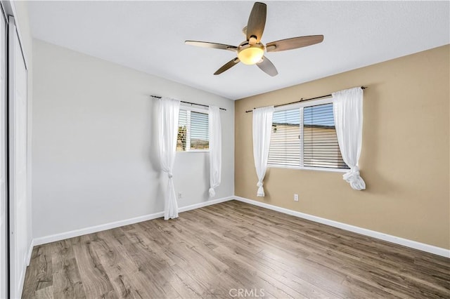 57330 Old Haggard Rd, Yucca Valley, CA 92284 - empty room featuring wood finished floors, ceiling fan, and baseboards