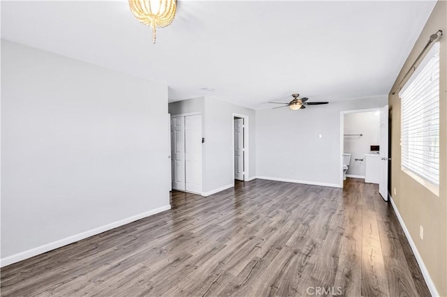 57330 Old Haggard Rd, Yucca Valley, CA 92284 - unfurnished living room with wood finished floors, a ceiling fan, and baseboards