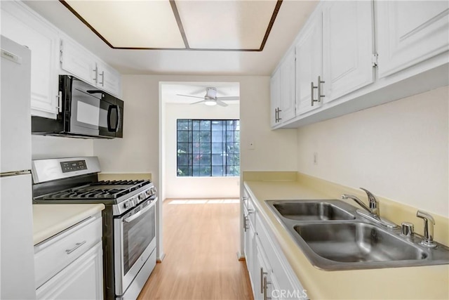 600 Central Ave Unit 372, Riverside, CA 92507 - kitchen with stainless steel range with gas cooktop, black microwave, a sink, freestanding refrigerator, and a ceiling fan