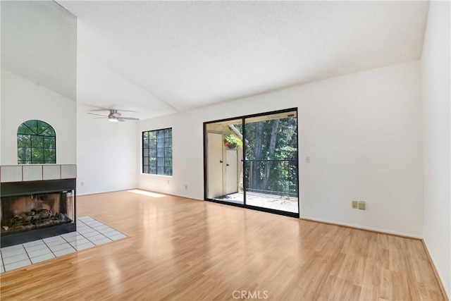 600 Central Ave Unit 372, Riverside, CA 92507 - unfurnished living room with wood finished floors, lofted ceiling, ceiling fan, and a tiled fireplace