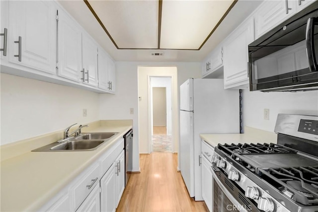 600 Central Ave Unit 372, Riverside, CA 92507 - kitchen featuring appliances with stainless steel finishes, a sink, light wood finished floors, and white cabinets
