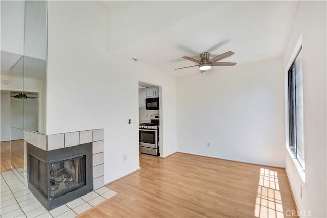 600 Central Ave Unit 372, Riverside, CA 92507 - unfurnished living room with a ceiling fan, wood finished floors, and a tile fireplace