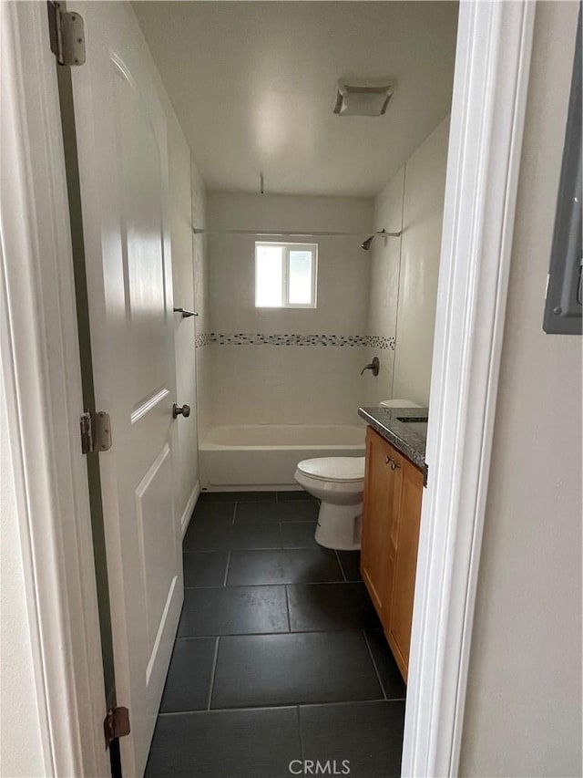 full bath featuring tile patterned flooring,  shower combination, toilet, and vanity