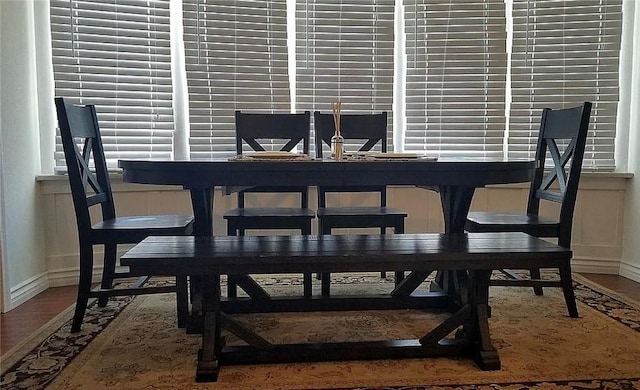 dining room with baseboards and wood finished floors