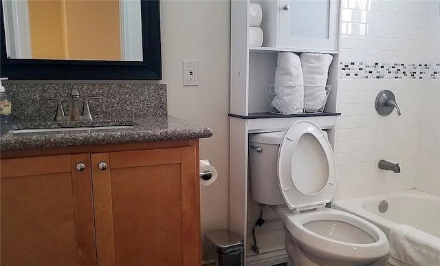 bathroom with toilet, vanity, and bathtub / shower combination