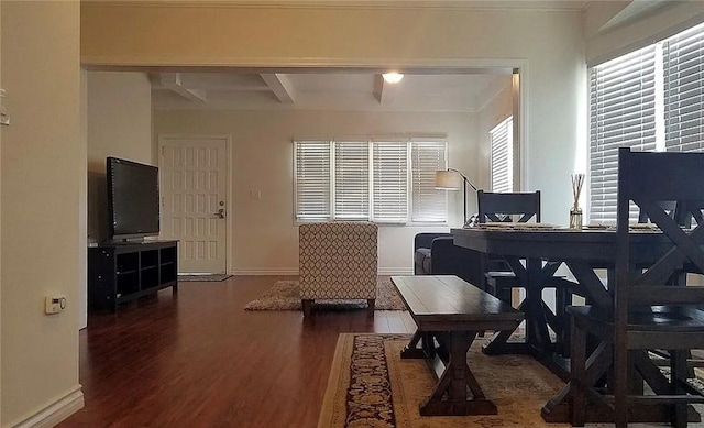 dining area featuring wood finished floors, baseboards, beamed ceiling, and an office area