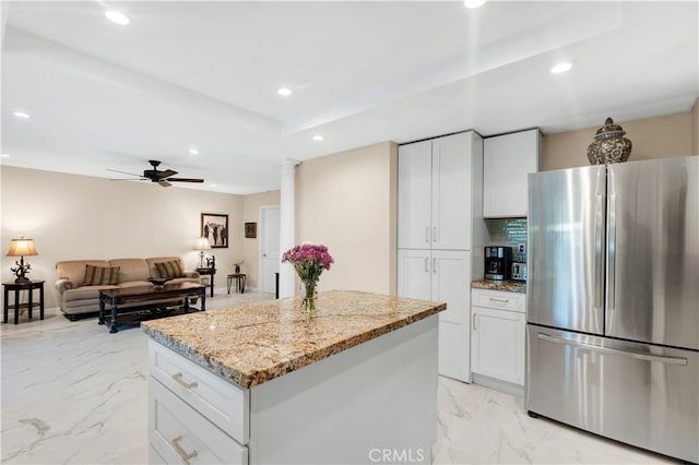 7936 Laramie Ave, Winnetka, CA 91306 - kitchen featuring freestanding refrigerator, a kitchen island, light marble finish floors, recessed lighting, and light stone countertops