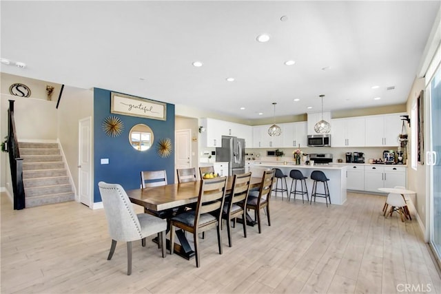 1212 Venice Ave, Mentone, CA 92359 - dining space featuring light wood finished floors, recessed lighting, stairway, baseboards, and plenty of natural light