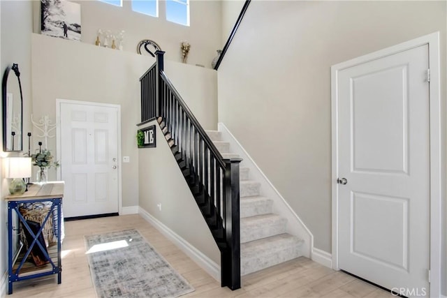 1212 Venice Ave, Mentone, CA 92359 - foyer entrance featuring stairway, wood finished floors, baseboards, and a high ceiling