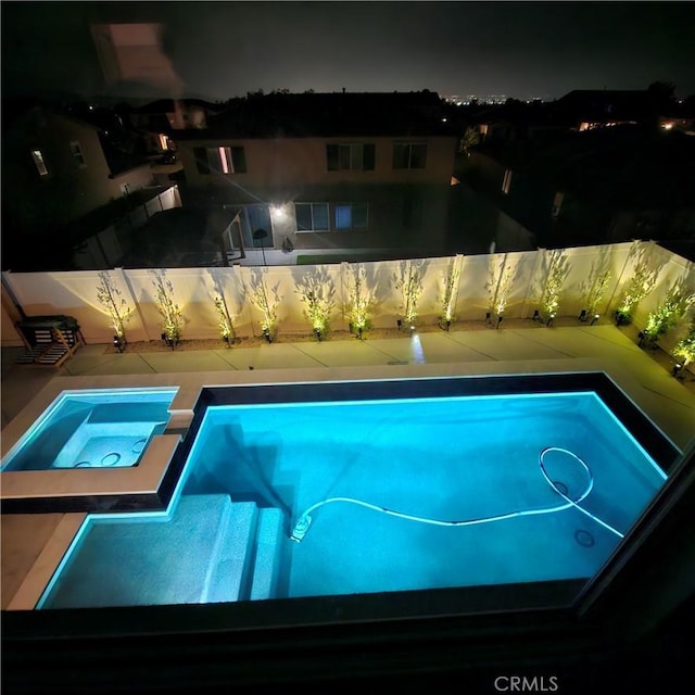 1212 Venice Ave, Mentone, CA 92359 - pool at twilight featuring fence and a pool with connected hot tub