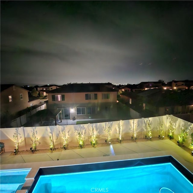 1212 Venice Ave, Mentone, CA 92359 - pool at twilight with a fenced backyard
