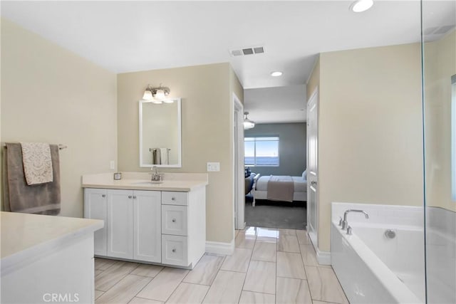 1212 Venice Ave, Mentone, CA 92359 - bathroom featuring vanity, a bath, baseboards, recessed lighting, and connected bathroom