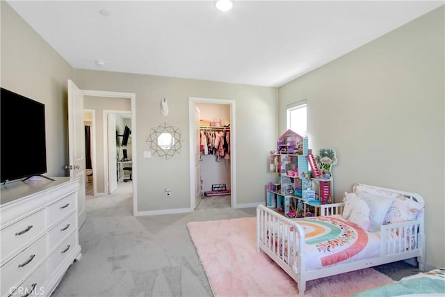1212 Venice Ave, Mentone, CA 92359 - bedroom featuring a walk in closet, light carpet, and baseboards