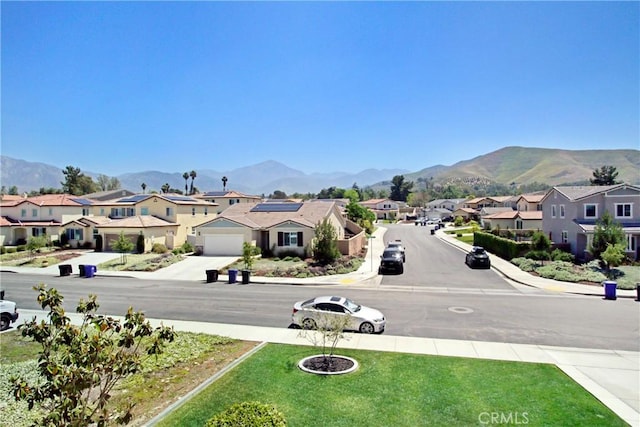1212 Venice Ave, Mentone, CA 92359 - view of asphalt street featuring a residential view, sidewalks, a mountain view, and curbs