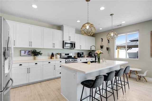 1212 Venice Ave, Mentone, CA 92359 - kitchen featuring appliances with stainless steel finishes, light wood-style floors, white cabinets, and recessed lighting