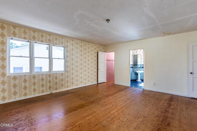 2577 Boulder Rd, Altadena, CA 91001 - empty room with wood finished floors, baseboards, wallpapered walls, and healthy amount of natural light