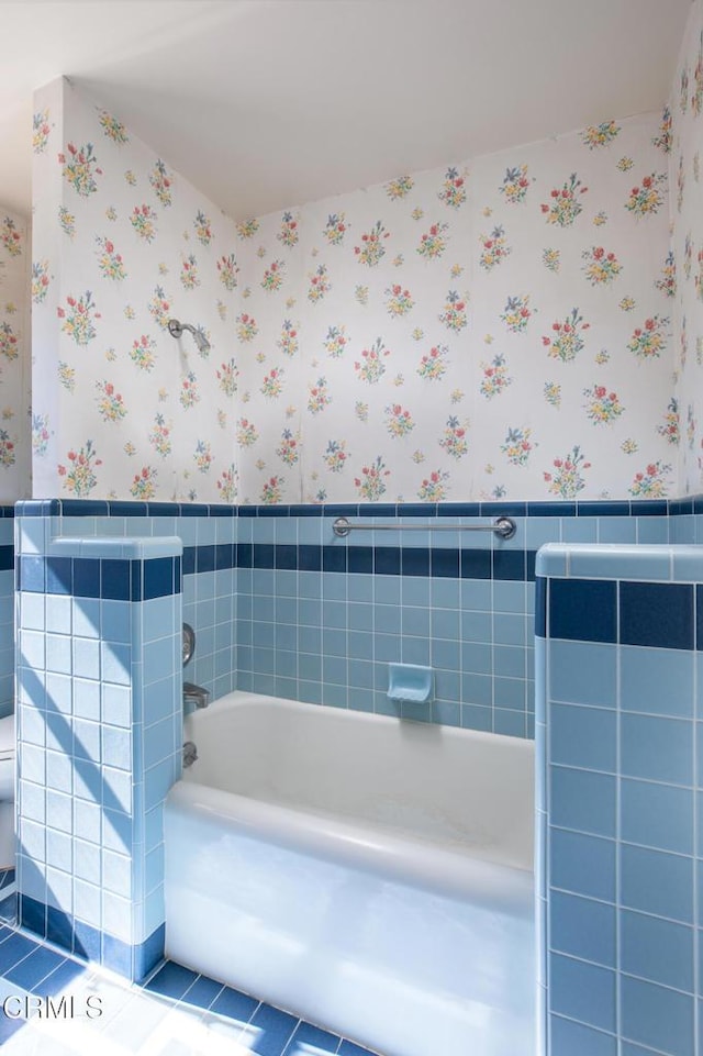 2577 Boulder Rd, Altadena, CA 91001 - bathroom featuring wallpapered walls, wainscoting, a bath, tile walls, and tile patterned floors