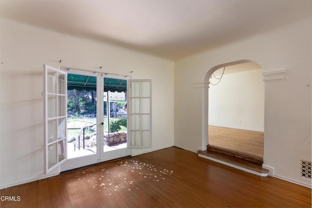 2577 Boulder Rd, Altadena, CA 91001 - unfurnished room with arched walkways, wood finished floors, french doors, and baseboards