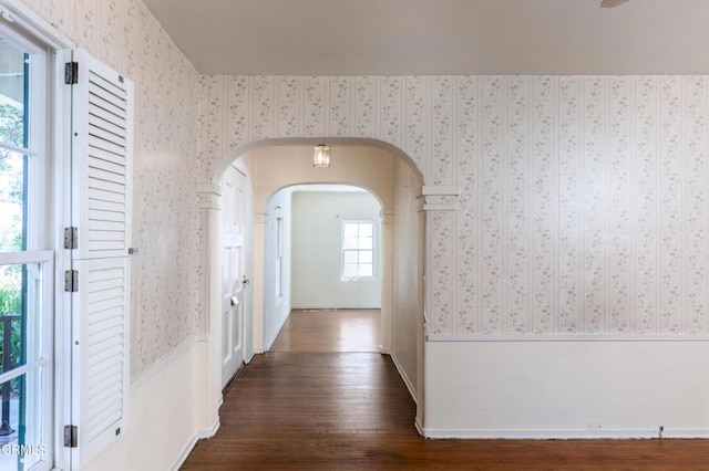 2577 Boulder Rd, Altadena, CA 91001 - hallway featuring wallpapered walls, arched walkways, and dark wood-style flooring