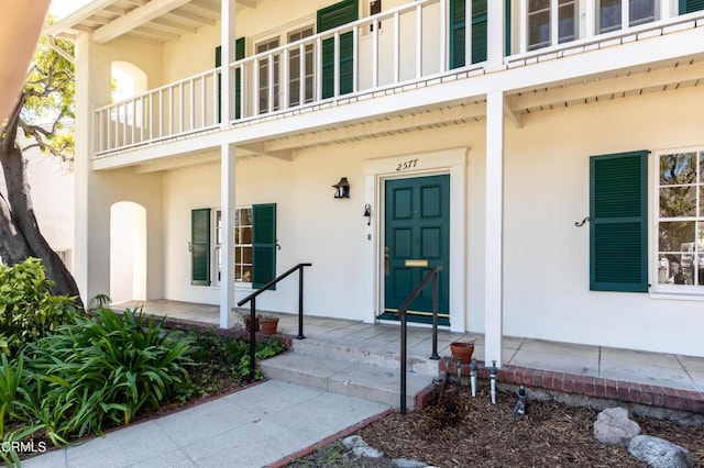 2577 Boulder Rd, Altadena, CA 91001 - view of exterior entry with stucco siding, a balcony, and a porch