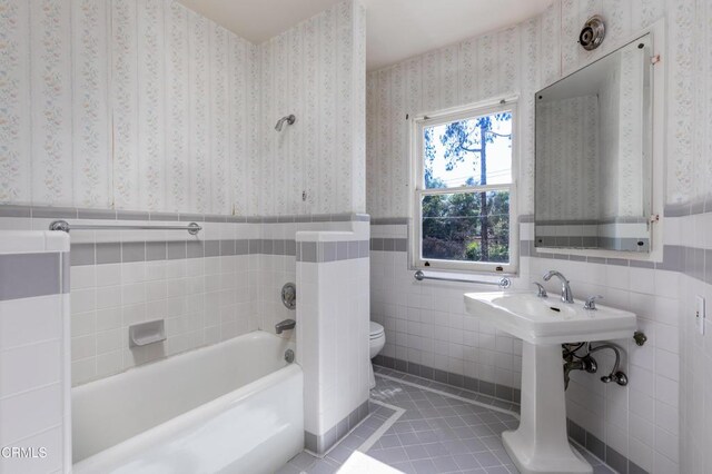 2577 Boulder Rd, Altadena, CA 91001 - full bathroom with tile patterned flooring, a bath, tile walls, a wainscoted wall, and wallpapered walls