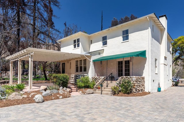 2577 Boulder Rd, Altadena, CA 91001 - rear view of property with stucco siding, a pergola, and a chimney