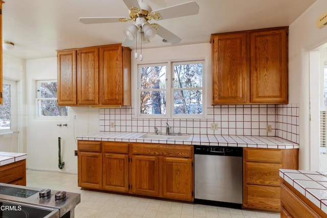 2577 Boulder Rd, Altadena, CA 91001 - kitchen with dishwasher, tile countertops, brown cabinetry, and backsplash
