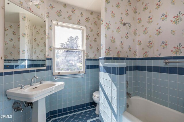 2577 Boulder Rd, Altadena, CA 91001 - bathroom featuring wainscoting, a bathtub, tile walls, tile patterned flooring, and wallpapered walls