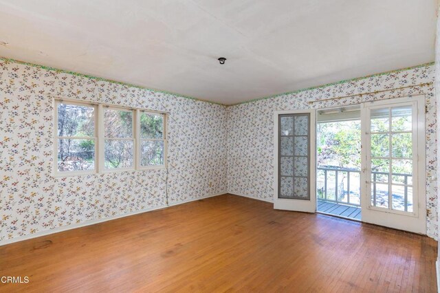 2577 Boulder Rd, Altadena, CA 91001 - empty room featuring wood finished floors, wallpapered walls, and fire sprinkler in ceiling