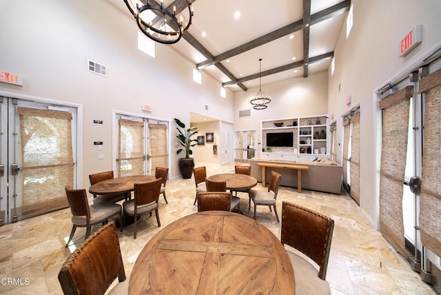 dining area featuring a towering ceiling, a chandelier, beamed ceiling, french doors, and recessed lighting