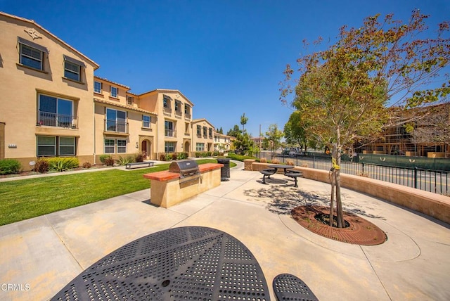 surrounding community featuring an outdoor kitchen, a residential view, and a patio