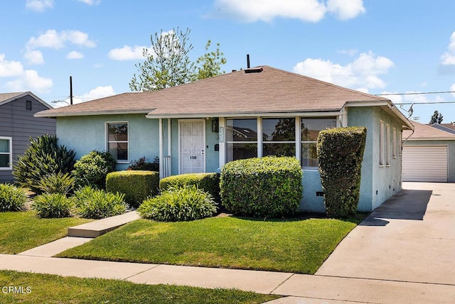2327 Roscommon Ave, Monterey Park, CA 91754 - view of front of property featuring stucco siding, a front lawn, a shingled roof, a garage, and an outbuilding