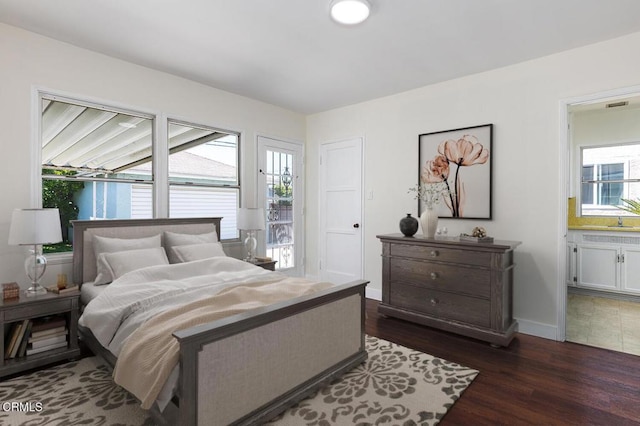 2327 Roscommon Ave, Monterey Park, CA 91754 - bedroom with dark wood-style flooring, ensuite bath, and baseboards